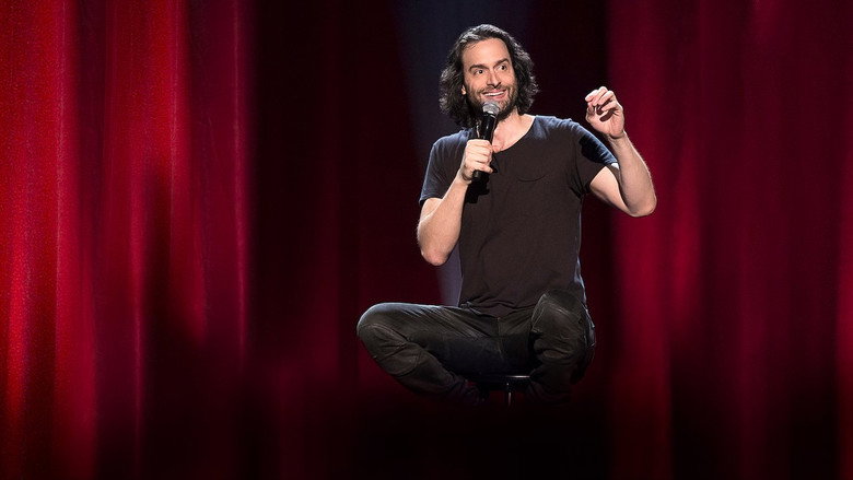 Chris D’Elia mid-performance, arms outstretched, grinning at the audience