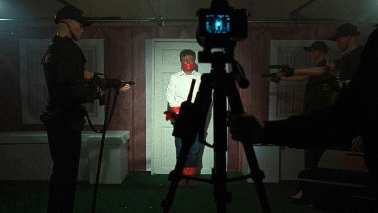 A dimly lit, sterile moderation suite with glowing screens reflecting in a glass partition