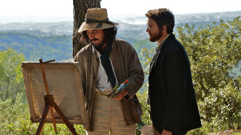 Two men stand on a rocky outcrop, the wind tugging at their coats, their faces turned away from each other.