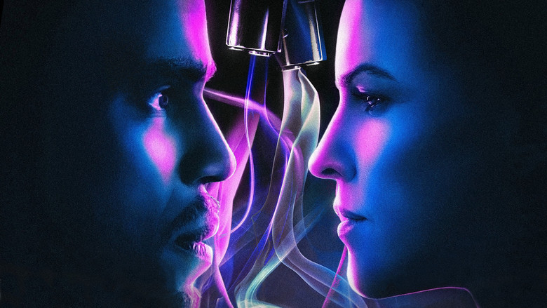 A dimly lit bedroom, the camera angled low, capturing the tense exchange between two figures—one standing, one sitting—bathed in the cold glow of a bedside lamp.