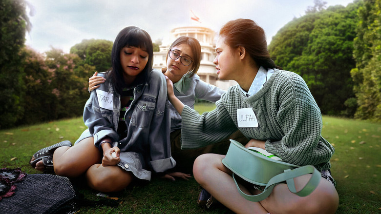 Three girls stand at the threshold of a sunlit compound, their faces half in shadow, half in golden light.