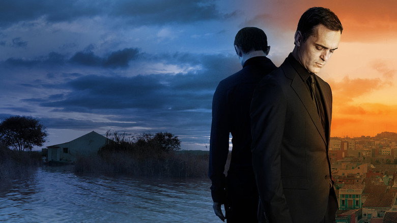 A shadowy figure stands in the reeds of a marsh at dusk, the water reflecting a distorted, almost painterly version of the landscape.