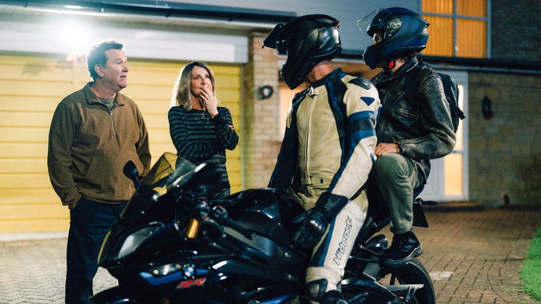 A motorcycle driving through a dark street