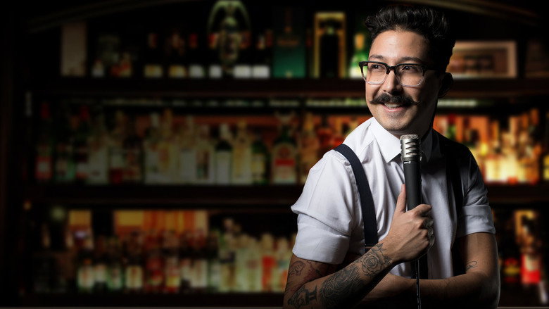 Mau Nieto on stage, mic in hand, mid-laugh, the bar lights casting a warm but uneven glow over the crowd