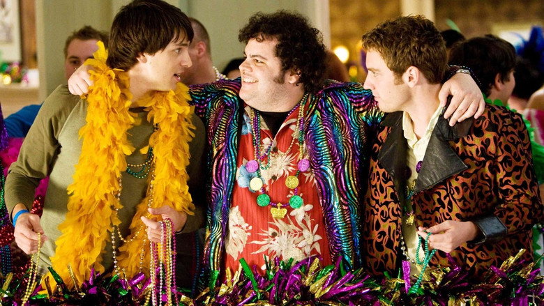 Three college guys in drag, looking awkwardly at the camera in a hotel hallway