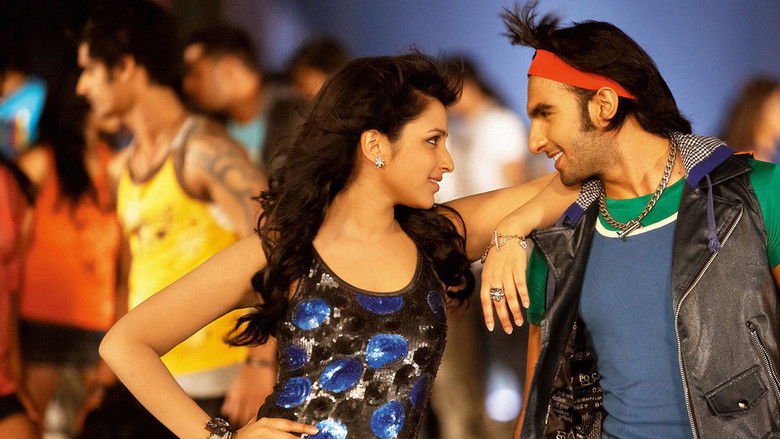 A close-up of Ranveer Singh as Ricky Bahl, his face half-lit by a smirk, his eyes gleaming with mischief