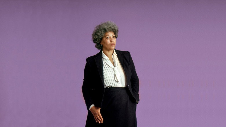 Toni Morrison seated, her hands clasped, looking directly at the camera with a quiet intensity