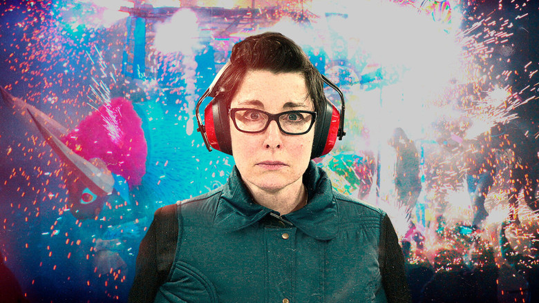 Sue Perkins mid-adventure, surrounded by lush greenery, her expression a mix of amusement and mild terror
