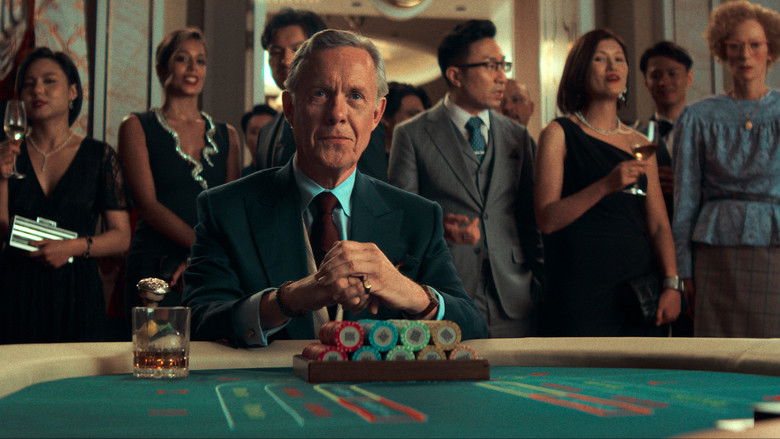 Two figures talking quietly on a dimly lit balcony
