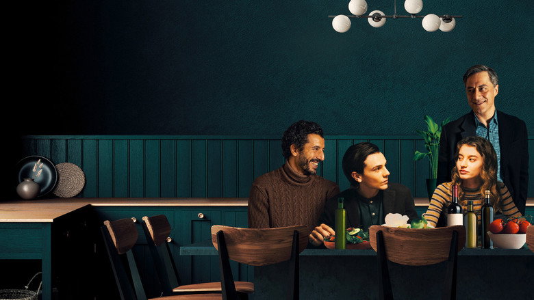 A family dinner scene, warmly lit but with an undercurrent of tension