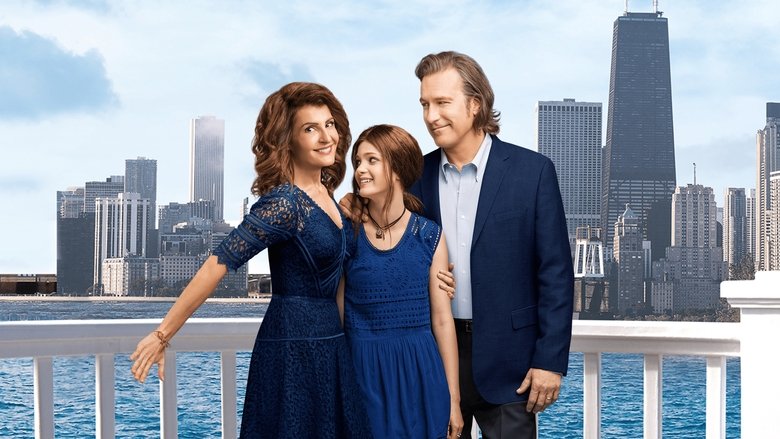 A chaotic family dinner with the Portokalos clan gathered around a long table, plates of food everywhere, and Toula (Nia Vardalos) looking overwhelmed in the center.