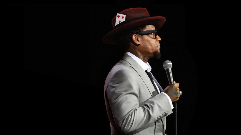 D.L. Hughley on stage, mid-gesture, his expression caught between a smirk and a grimace