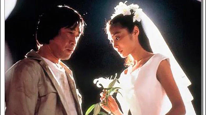 A quiet moment between Shūji and Yuriko, their faces half-lit by soft evening light