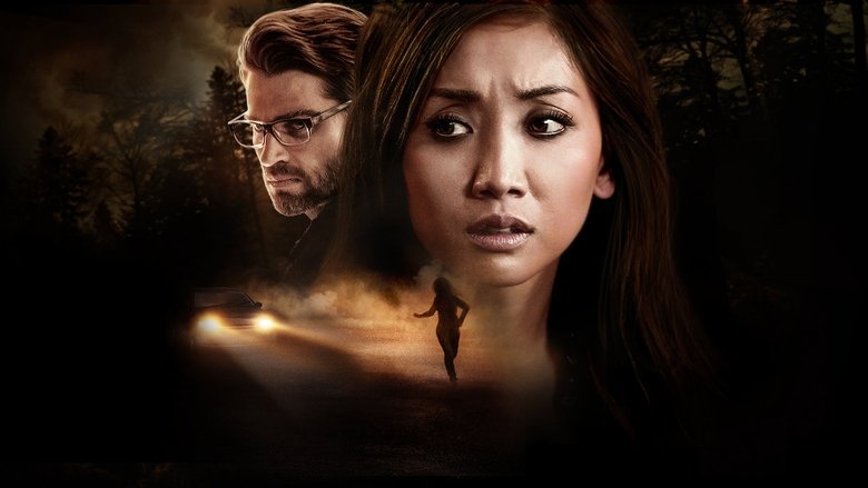 A dimly lit hospital room, the camera angled down at Brenda Song's character, her face half-shadowed, her expression a mix of confusion and fear.