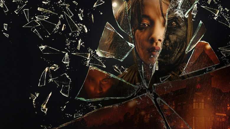 A dimly lit room where Carissa Perusset’s character, Ratna, stands in a blood-red dress, her face half-shadowed as she stares at something off-camera with an expression caught between fear and defiance.