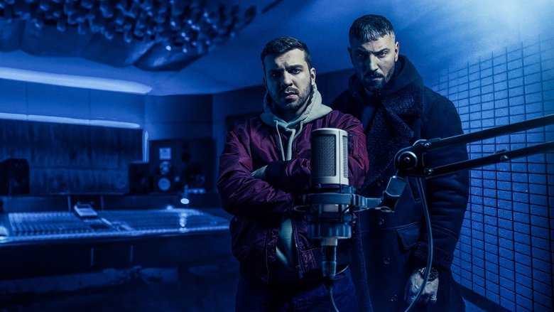 A dimly lit recording studio, where Kalil and his crew huddle around a mixing board, the glow of the sound waves casting long shadows on their faces.