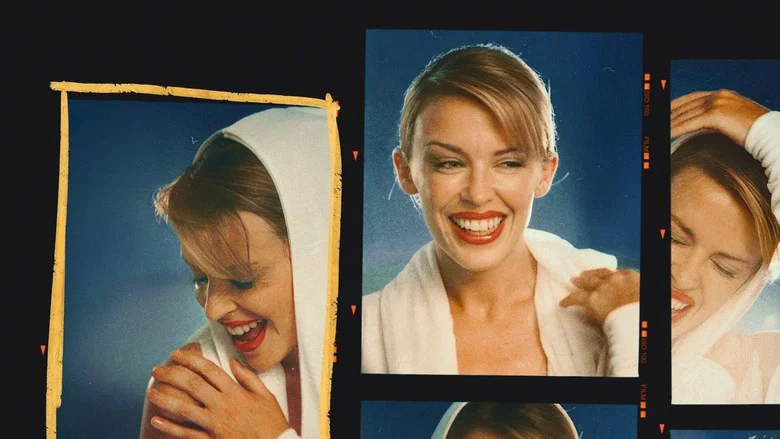 Kylie Minogue in her archive room, surrounded by boxes of memories, laughing at an old home video