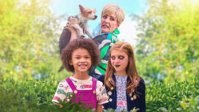 Two girls sit cross-legged on a sunlit porch, one whispering into the other's ear as if sharing a grand conspiracy.