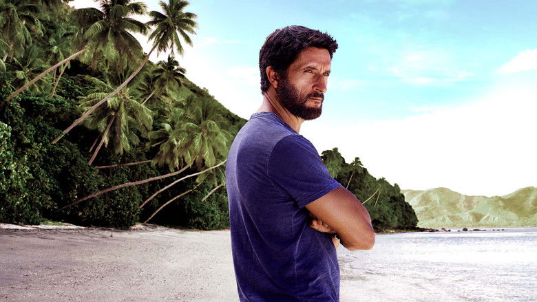 A wide shot of a desolate, windswept beach where the contestants huddle during a storm.