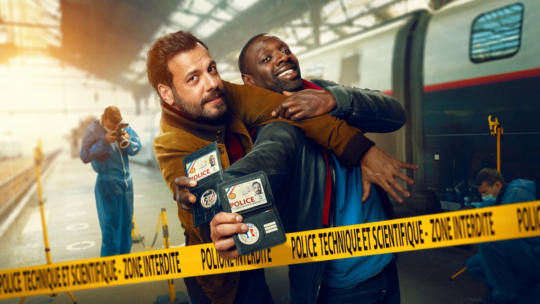Two cops in a car, one looking exasperated, the other grinning