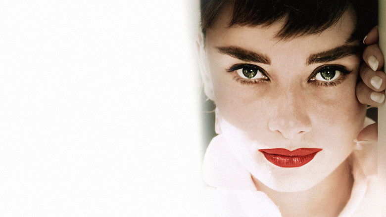 Audrey Hepburn in a black Givenchy dress, mid-dance, her face half in shadow