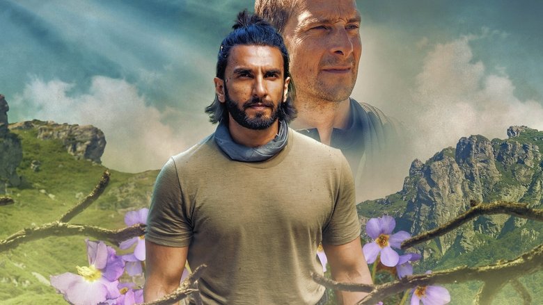 Ranveer Singh and Bear Grylls standing in a misty forest, the former looking determined, the latter pointing toward an unseen goal