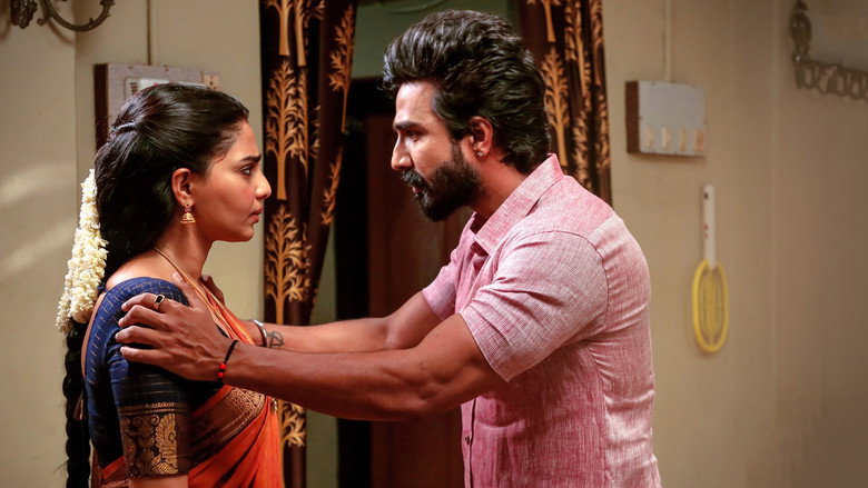 A still from *Gatta Kusthi* showing Vishnu Vishal and Aishwarya Lekshmi in a tense moment, their faces half-lit by warm light, the tension between them almost palpable.