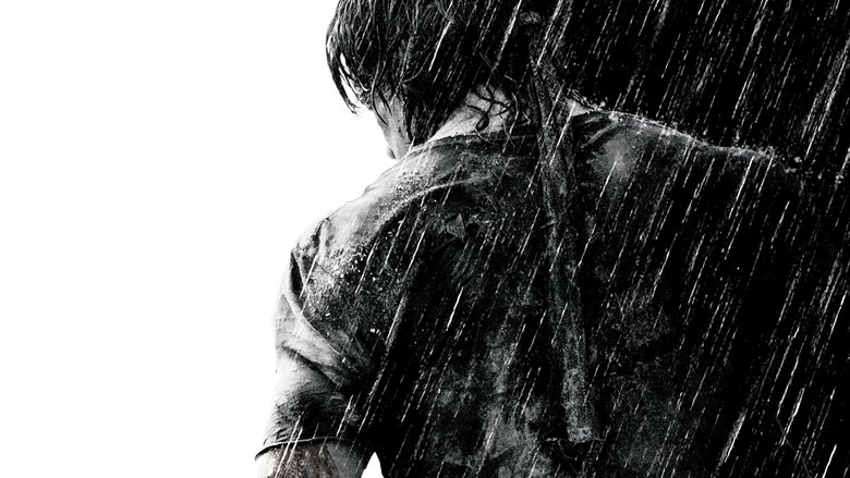 John Rambo drawing his bow in the rain