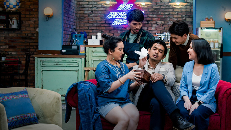 The five main characters sitting in a circle at their café support group, bathed in warm, golden light.