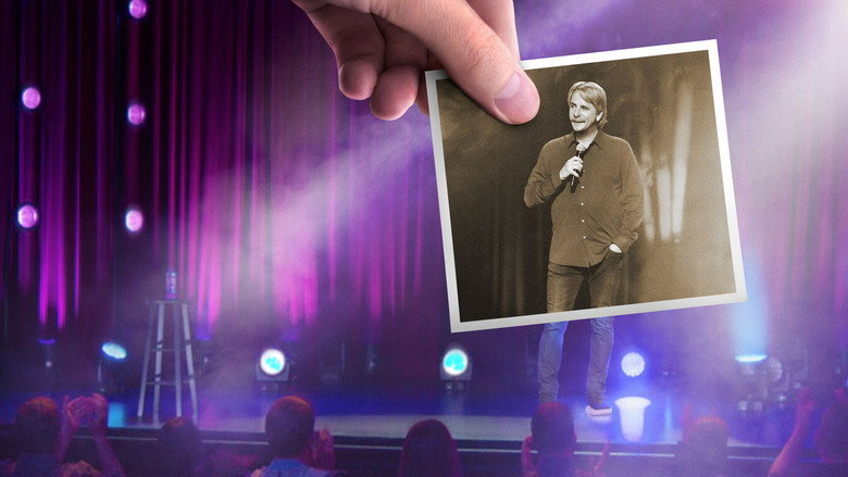 Jeff Foxworthy on stage, bathed in warm light, gesturing to the audience