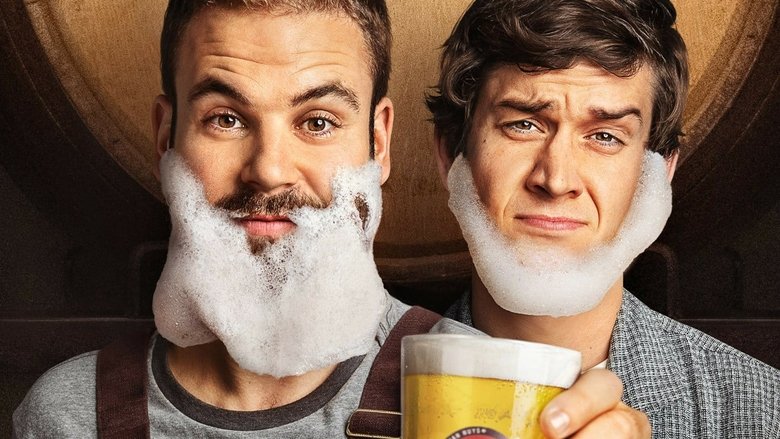 Two brothers stand in a cluttered brewery, one holding a clipboard with a look of disdain, the other grinning with a beer in hand