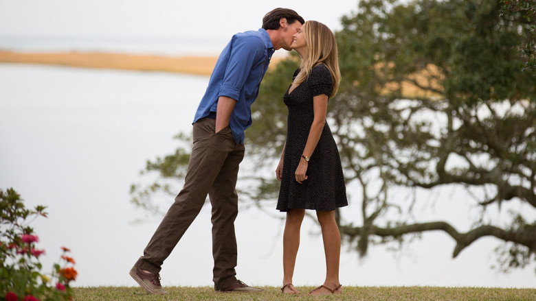 A quiet moment between Travis and Gabby on a sunlit porch, the ocean stretching out behind them