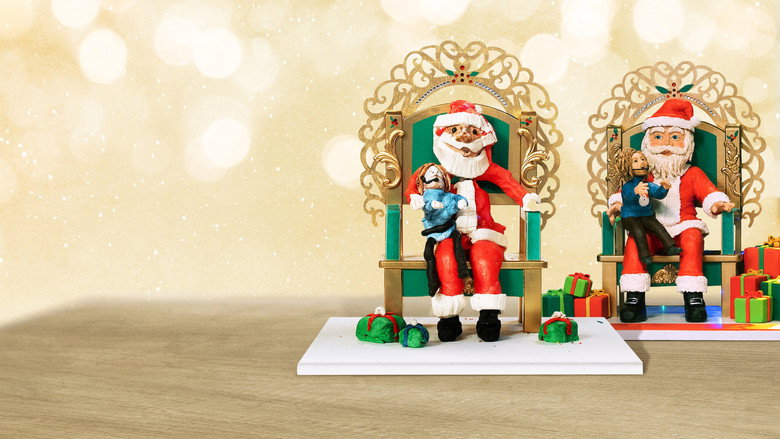 A contestant's lopsided gingerbread house, its walls slumping like a tired sigh, while Nicole Byer and Jacques Torres exchange amused glances in the background.