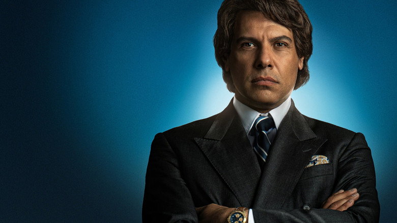 A close-up of Laurent Lafitte as Bernard Tapie, mid-speech, his face lit with the intensity of a man selling a lie as truth.