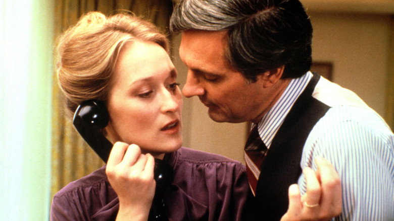 A dimly lit office, papers strewn across a desk, Alan Alda and Meryl Streep in quiet conversation