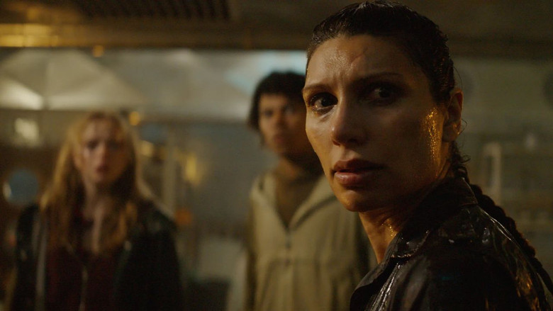 Johanne looking out over the dark, fog-covered waters of the fjord