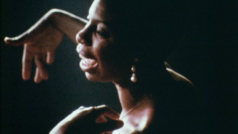 Nina Simone at the piano, her hands poised over the keys, her expression a mix of concentration and intensity