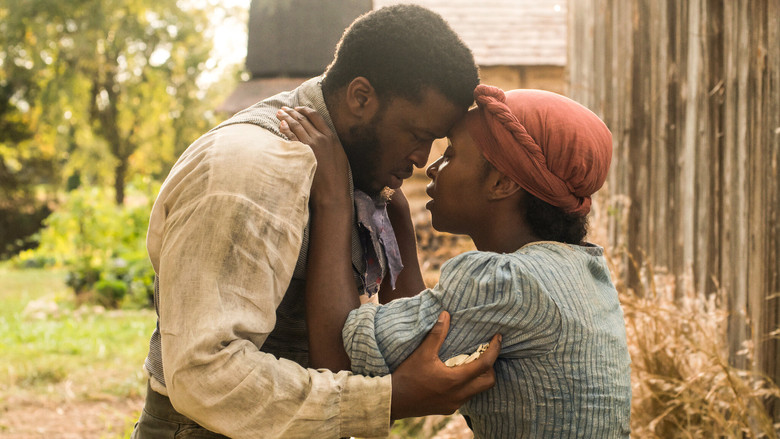 A close-up of Cynthia Erivo as Harriet Tubman, her face half-lit by firelight, eyes wide with a mix of fear and determination.