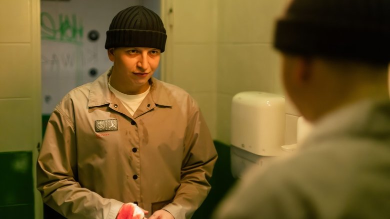 A tense standoff in a dimly lit alley, the camera tight on the protagonist’s face as he clutches a wad of cash, his expression a mix of fear and desperation.