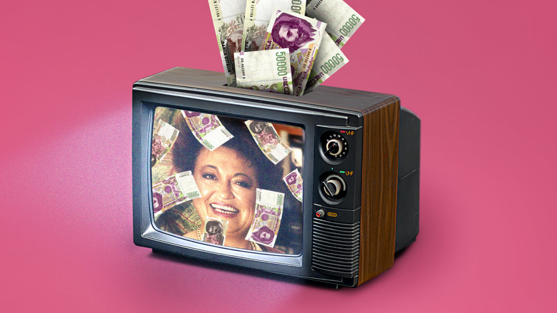 A close-up of a television screen showing Wanna Marchi mid-pitch, her face lit by the glow of the studio lights, her expression a mix of sincerity and something darker.