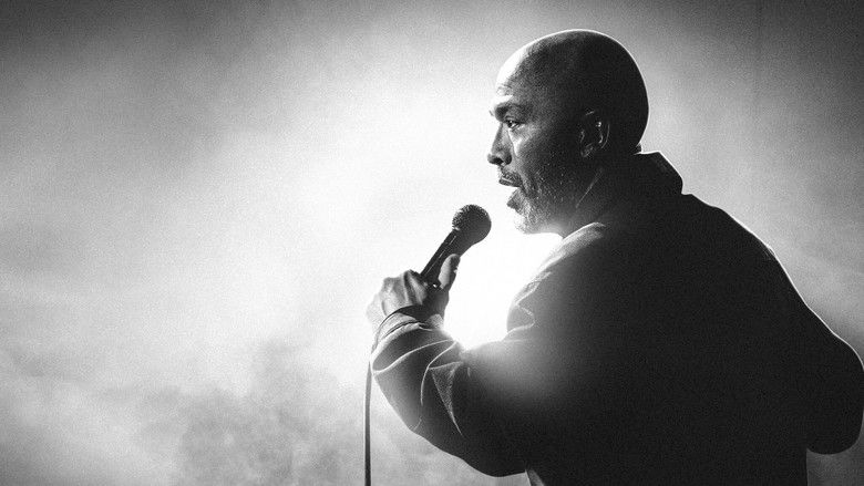 Jo Koy on stage at the Los Angeles Forum, bathed in warm light, arms outstretched as the crowd roars