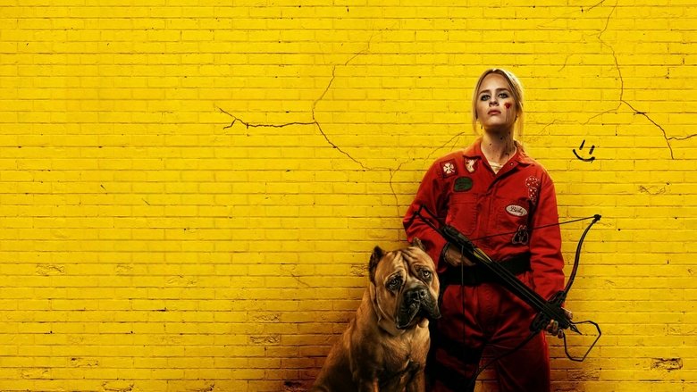 Becky stands in a dimly lit room, machete in hand, her face smeared with blood and dirt, eyes locked on her unseen target.