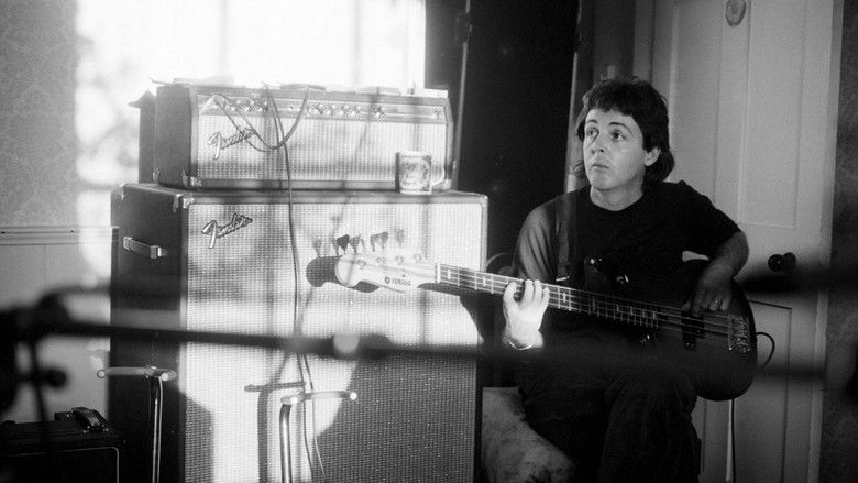 A wide, slightly out-of-focus shot of a stage during an early Wings tour, emphasizing the contrast between the intimacy of the performance and the enormity of the audience's expectations