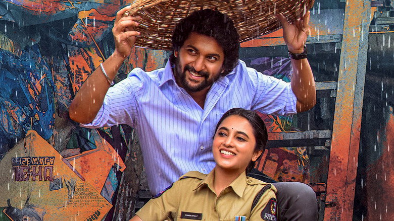 A close-up of Nani’s character, Surya, holding a red scarf, his face half-lit by the glow of a streetlamp, the tension in his jaw visible even in the dim light.