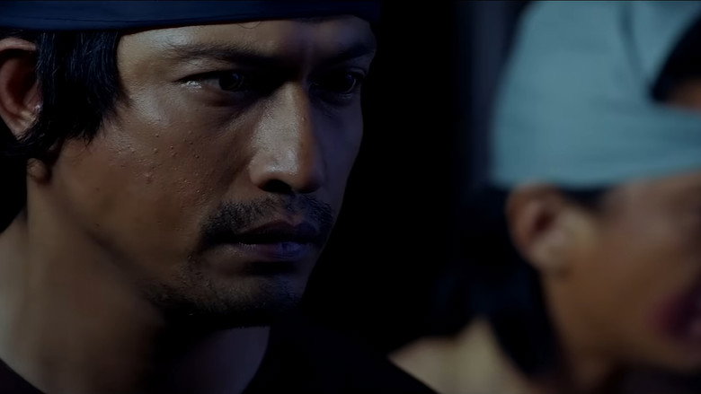 A tense standoff in a dimly lit room, where a group of Malay warriors face off against British soldiers, the flickering torchlight casting long shadows.