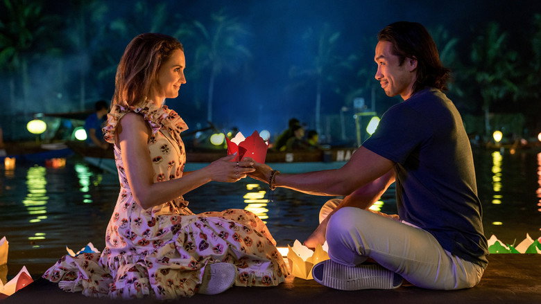 Amanda and Sinh strolling through a lantern-lit street in Hoi An, the glow of the lights reflecting in their smiles