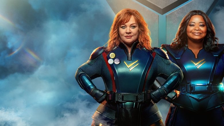 Two women in matching superhero suits stand back-to-back, one looking determined, the other slightly exasperated