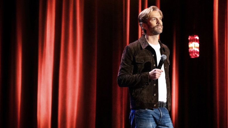 Jeselnik on stage, deadpan, holding a microphone like it's a weapon