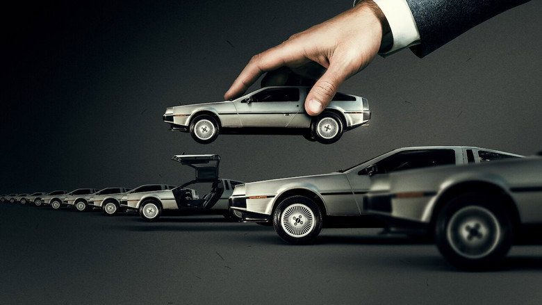 A close-up of John DeLorean’s face, half in shadow, as he speaks to an unseen interviewer