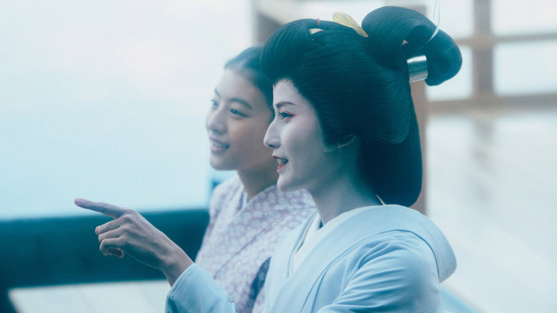 Sumire in her maiko makeup and kimono, standing in a sunlit courtyard, her posture elegant but her expression unreadable.